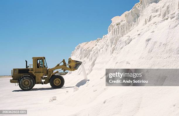 bulldozer truck loading salt at refining plant, spain - sales occupation fotografías e imágenes de stock