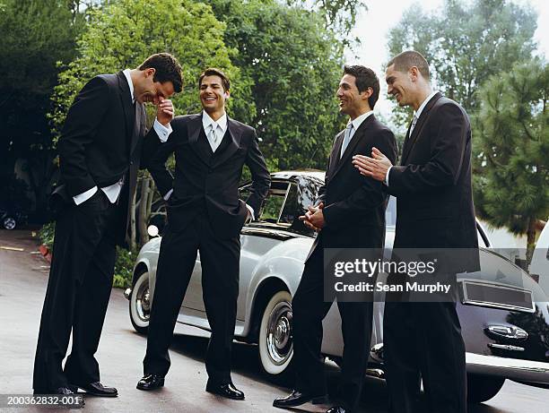 groom and groomsmen laughing - stationery elegant stockfoto's en -beelden