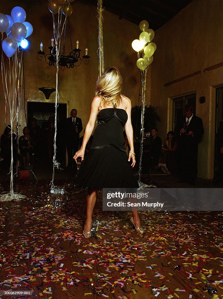 Young woman dancing alone at party