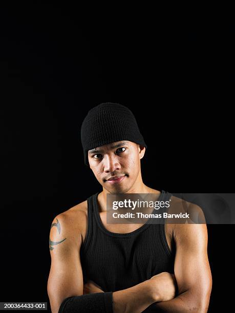 young man wearing knit hat, arms crossed, portrait - tank top ストックフォトと画像