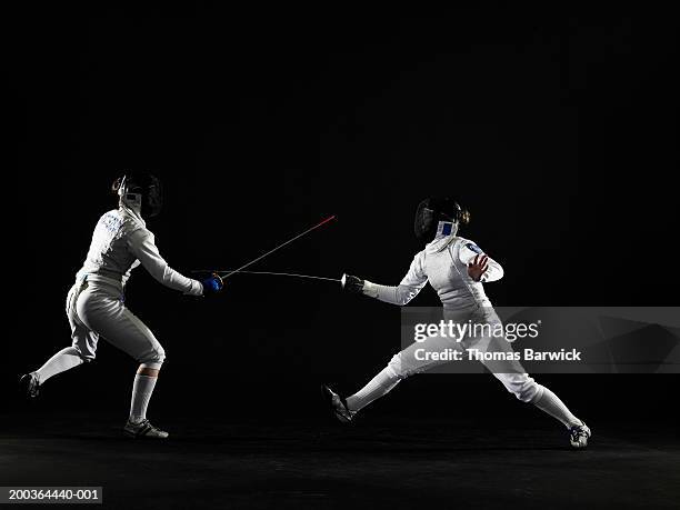 two teenage girls (15-18) fencing, side view - fioretto sport foto e immagini stock