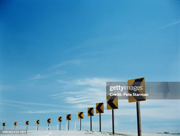 traffic arrows around bend in round - road safety stock pictures, royalty-free photos & images