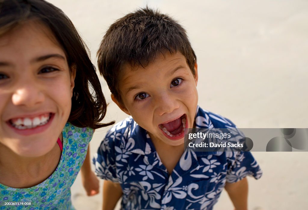 Girl and boy (6-8) smiling, portrait, close-up