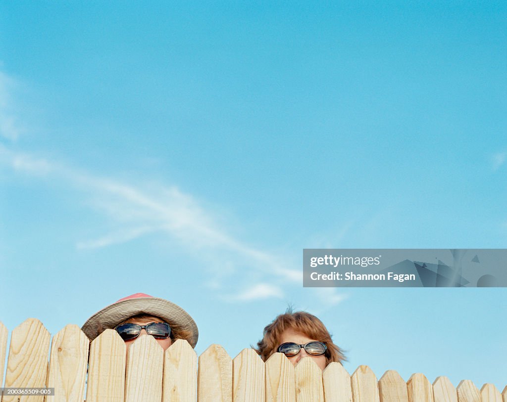 Two women looking over fence