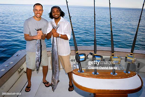 Two Men Holding Fish On Boat Portrait High-Res Stock Photo - Getty