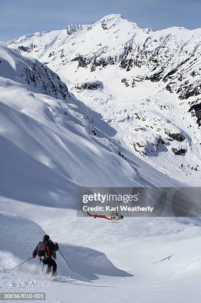 man heli skiing, whistler mountain, british columbia, canada, elevated view - heli skiing stock pictures, royalty-free photos & images
