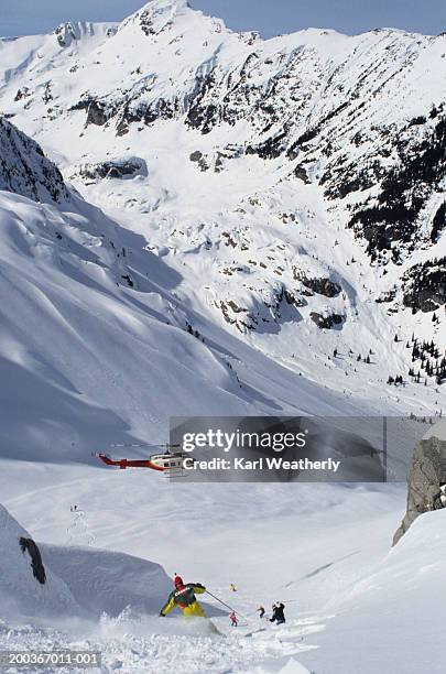 man heli skiing, whistler mountain, british columbia, canada, elevated view - heli skiing stock pictures, royalty-free photos & images