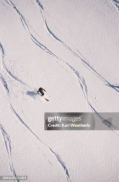 single skier surrounded by serpentine tracks, idaho, usa, overhead view - surrounding wall stock-fotos und bilder