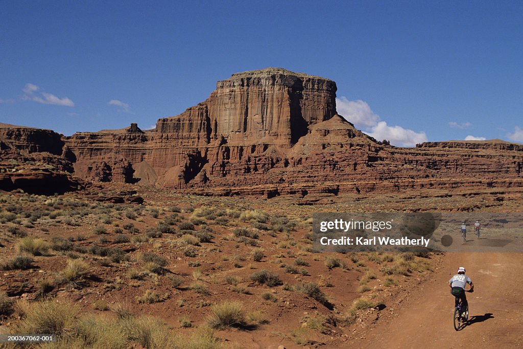 Mountain bikers on trail at Hurrah Pass, near Moab, Utah, USA