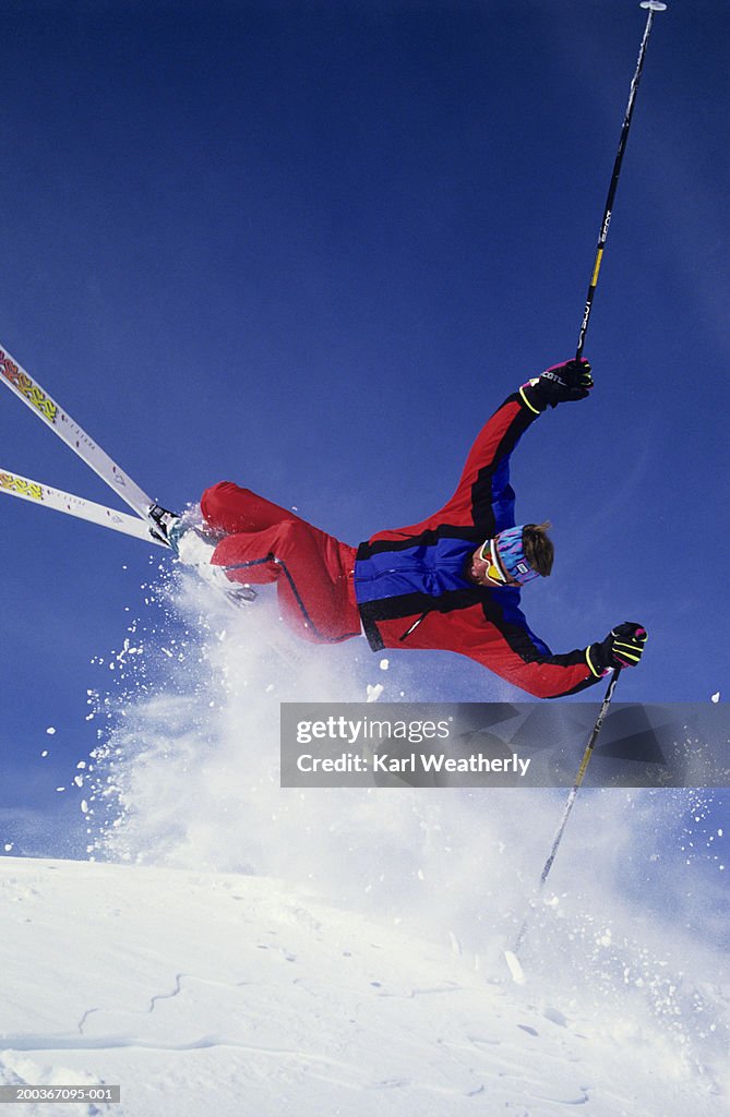 Skier mid-air, pole-plant