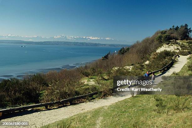 people on sandy trail, discovery park, seattle, washington, usa, elevated view - seattle stock pictures, royalty-free photos & images