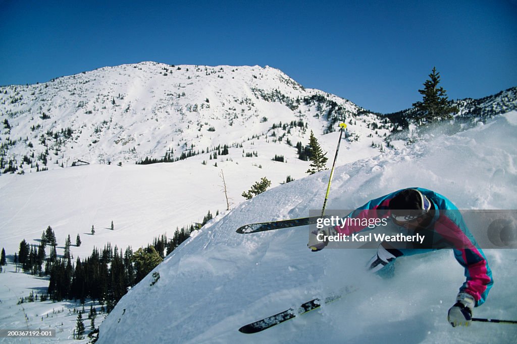 Man doing ski  manoeuvres on steep slope, Snowbird, Utah, USA, elevated view