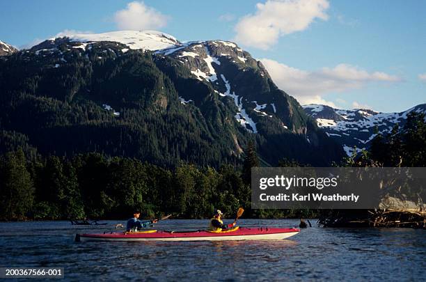 two people sea kayaking on stikine river, alaska, usa - stikine river stock pictures, royalty-free photos & images