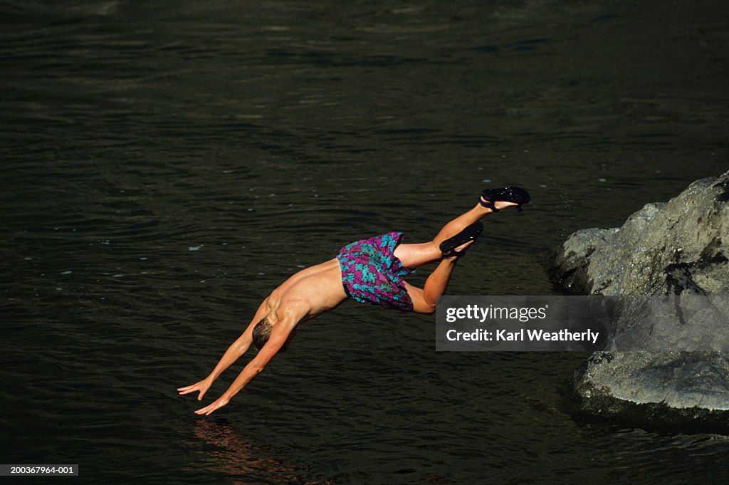 Diving In Between Two Rocks Male Diving Off Rock Into River Elevated View High-Res Stock Photo ...