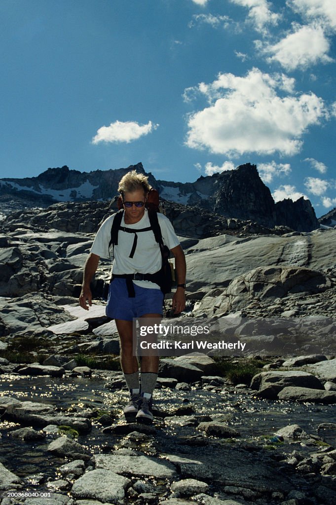 Young man hiking on rocky pass, the Enchantments, Washington, USA