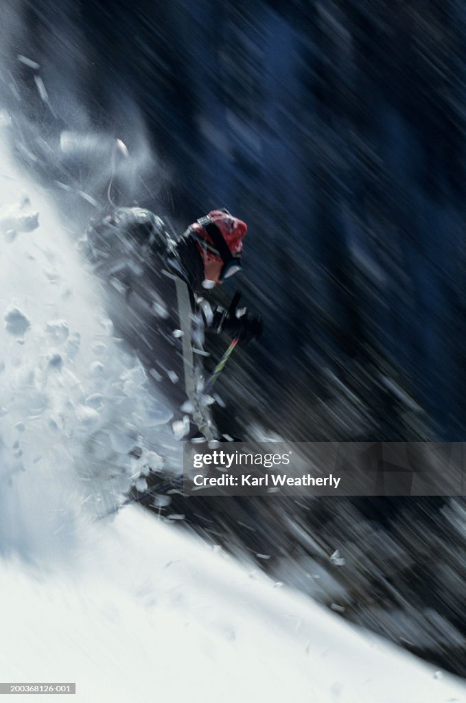 Man downhill skiing, blurred motion