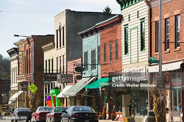 cars parked on street - small town stockfoto's en -beelden