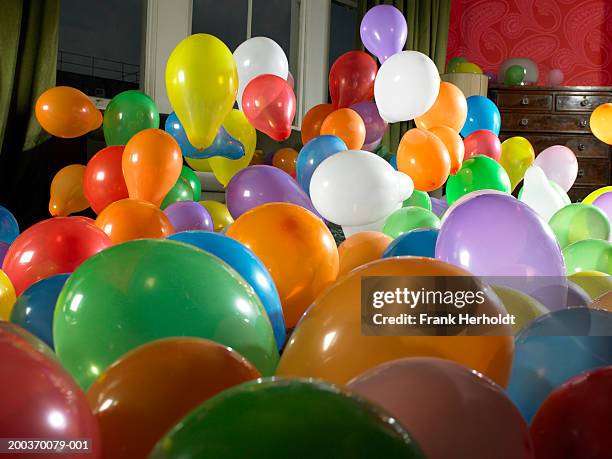 coloured balloons in living room - birthday balloons stock pictures, royalty-free photos & images