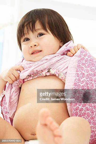 Toddler Girl Lifting Dress Closeup High-Res Stock Photo - Getty Images