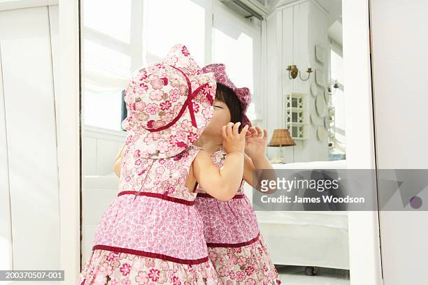 toddler girl (21-24 months) kissing reflection in mirror, rear view - one baby girl only bildbanksfoton och bilder