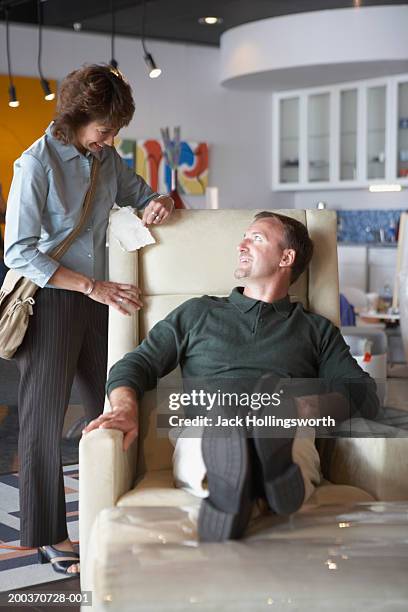 mid adult couple in a store - recliner chair stock pictures, royalty-free photos & images