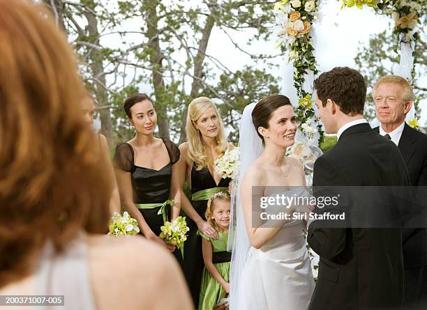 bride and groom getting married in garden - bride holding bouquet stock pictures, royalty-free photos & images