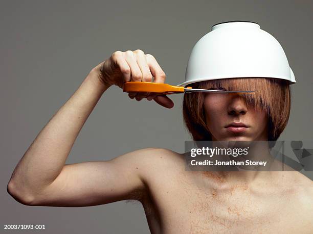 bare-chested man with bowl on head cutting fringe - slash stock pictures, royalty-free photos & images