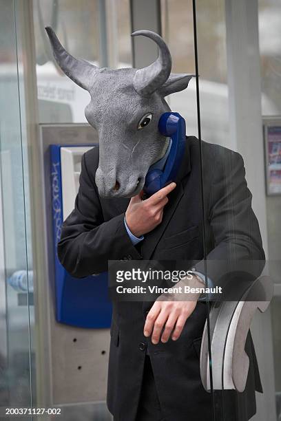 businessman wearing bull mask in telephone booth - telefonlur bildbanksfoton och bilder