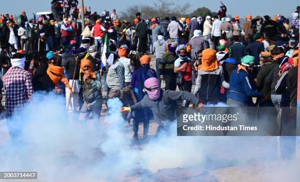 Protesters throw back theTear gas shell back to police personnel during the Farmers protest at Shambhu Border of Punjab and Haryana near Ambala, on...