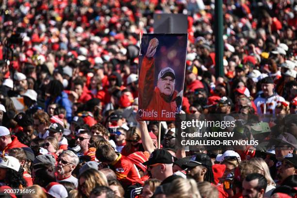 Fans hold up a sign featuring Kansas City Chiefs Head Coach Andy Reid during the Chiefs' Super Bowl LVIII victory parade on February 14 in Kansas...