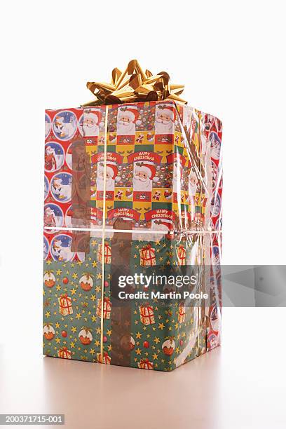 large gift wrapped with different christmas wrapping papers - bad gift wrap stock pictures, royalty-free photos & images