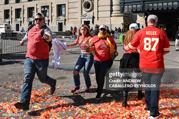 People flee after shots were fired near the Kansas City Chiefs' Super Bowl LVIII victory parade on February 14 in Kansas City, Missouri.
