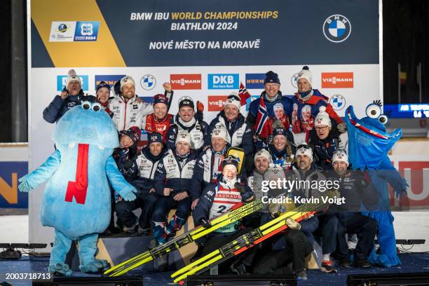 Tarjei Boe of Norway and Johannes Thingnes Boe of Norway celebrates with the team after the medal ceremony for the Men 20 km Individual at the IBU...