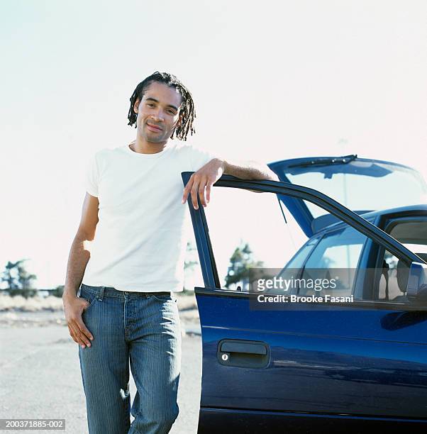 man leaning on open car door, portrait - vehicle door stock pictures, royalty-free photos & images