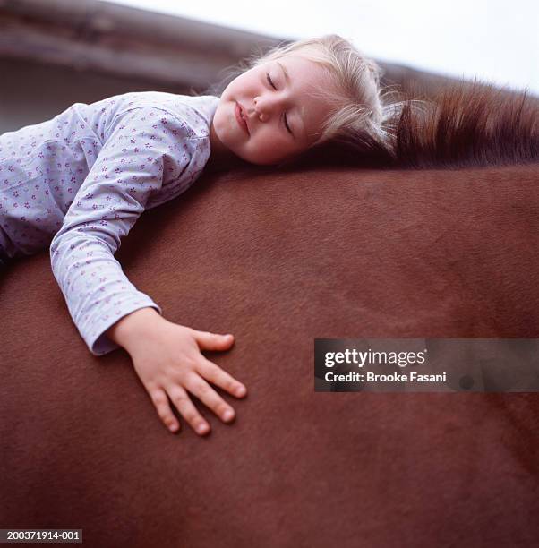 young girl (4-6) on horse with eyes closed - recreational horseback riding stock pictures, royalty-free photos & images