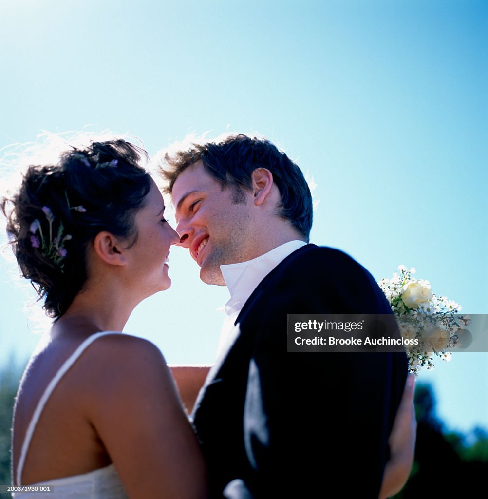 Bride and groom looking at each other, smiling