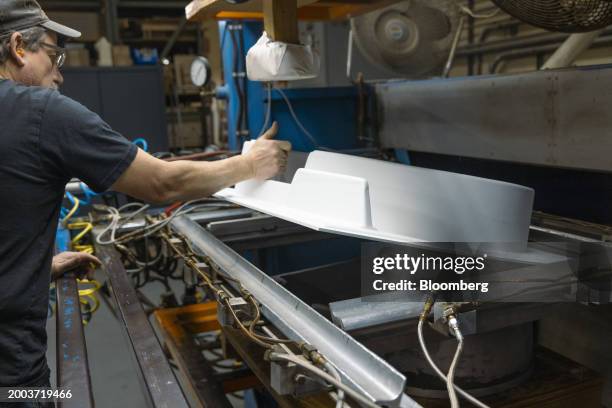 Worker handles a vacuum formed part for a potters wheel at the Usheco manufacturing facility in Kingston, New York, US, on Wednesday, Feb. 14, 2024....