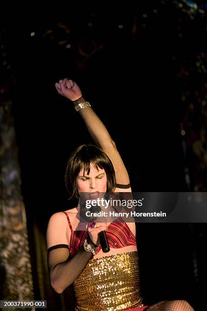 drag queen performing on stage, raising arm - diva human role stockfoto's en -beelden