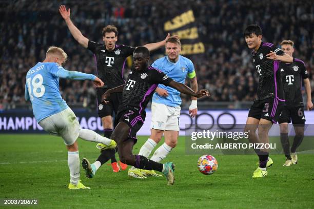 Lazio's Danish striker Gustav Isaksen fights for the ball with Bayern Munich's French defender Dayot Upamecano during the UEFA Champions League last...