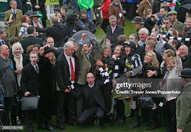 Irish Jockey Paddy Brennan with Imperial Commander and the owners - Syndicate; Our Friends In The North, after winning the Gold Cup at the Cheltenham...