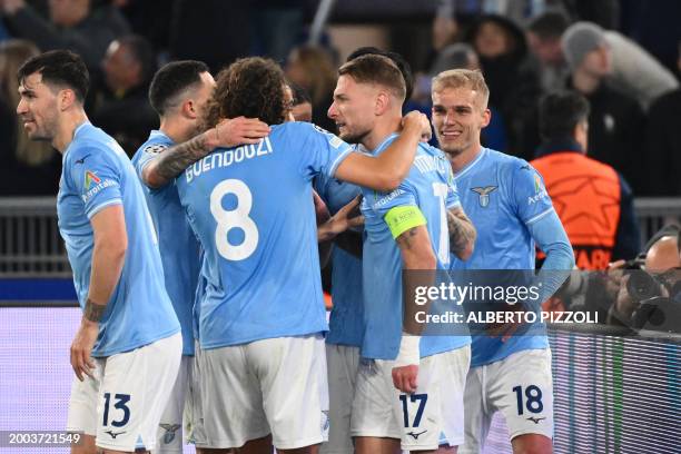 Lazio's Italian forward Ciro Immobile celebrates with teammates after scoring a penalty during the UEFA Champions League last 16 first leg between...