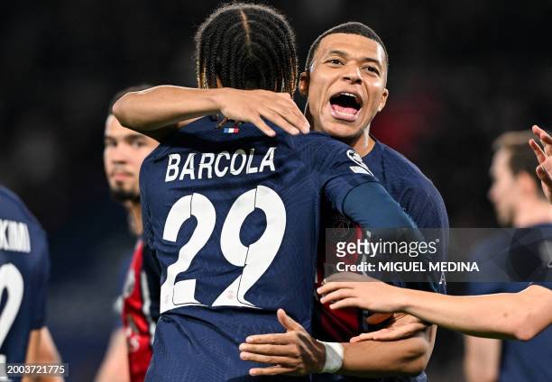 Paris Saint-Germain's French forward Bradley Barcola celebrates with Paris Saint-Germain's French forward Kylian Mbappe after scoring his team's...