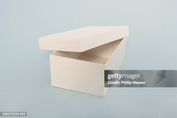 cover resting on cardboard box - shoe box stock pictures, royalty-free photos & images