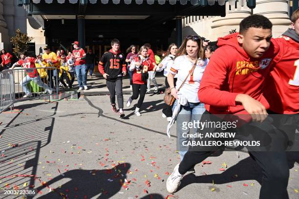 People flee after shots were fired near the Kansas City Chiefs' Super Bowl LVIII victory parade on February 14 in Kansas City, Missouri. A shooting...