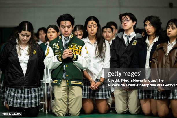 Riverside, CA Students kneel and pray during an Ash Wednesday service at Notre Dame High School in Riverside on Feb. 14, 2024.