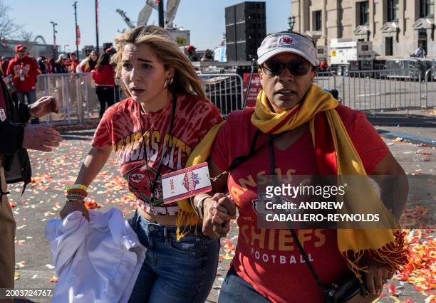 People flee after shots were fired near the Kansas City Chiefs' Super Bowl LVIII victory parade on February 14 in Kansas City, Missouri. A shooting...