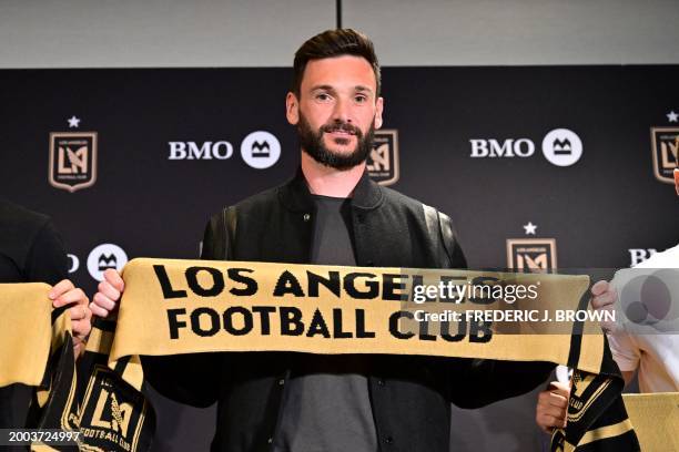 French goalkeeper Hugo Lloris poses with a Los Angeles FC scarf at a press conference after signing with LAFC in Los Angeles, California, on February...