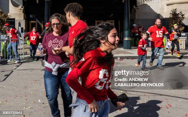 People flee after shots were fired near the Kansas City Chiefs' Super Bowl LVIII victory parade on February 14 in Kansas City, Missouri. A shooting...