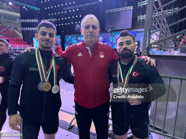 Turkish National Weightlifting Head Coach Isa Makal poses for a photo with Turkish National Team Athletes Kaan Kahriman winning gold, silver and...