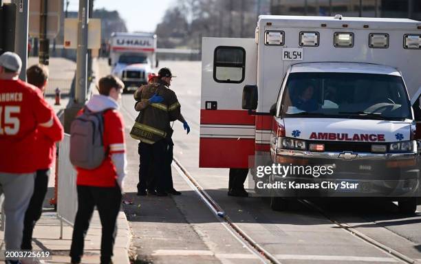 Firefighter waits outside an ambulance near Union Station after several people were shot near a rally there during the Kansas City Chiefs' Super Bowl...